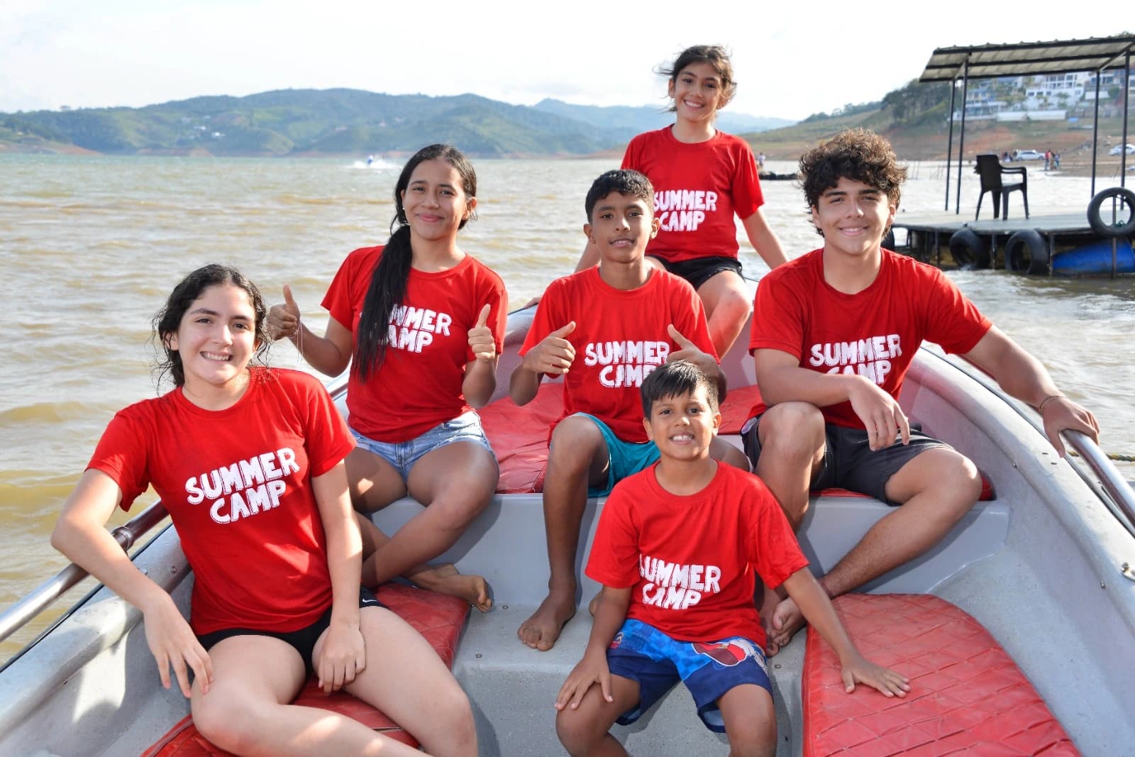 Niños celebrando con los brazos en alto en el Summer Camp